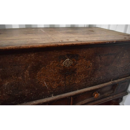 480 - A large Flemish oak coffer, with twin iron handles, two drawer front, and inlaid decoration surround... 