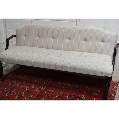 484 - A mahogany framed Georgian style window seat / three seater settee, with newly upholstered striped b... 