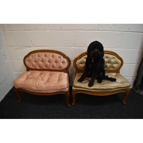 487 - A pair of antique French children's settees, upholstered in satin, button back and seat, raised on s... 