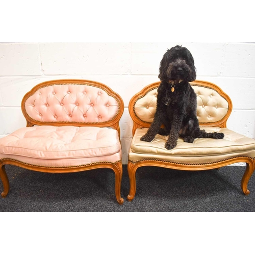 487 - A pair of antique French children's settees, upholstered in satin, button back and seat, raised on s... 