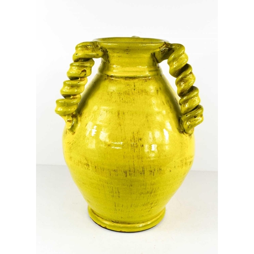 70 - A lime green glazed earthenware studio pottery vase with thee rope twist handles, 34cm high.