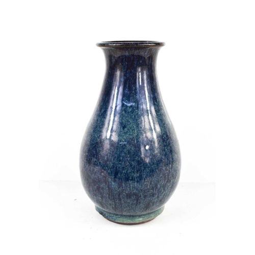 73 - A blue flambe glazed vase of baluster form, Chinese character mark to the base, 29cm high.