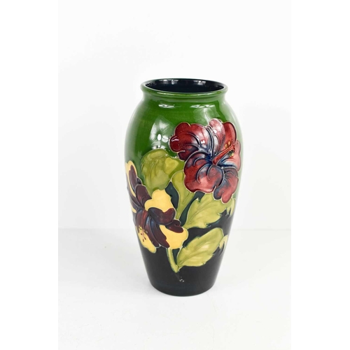 80 - A mid 20th century William Moorcroft vase in the Hibiscus pattern, of baluster form, the green groun... 