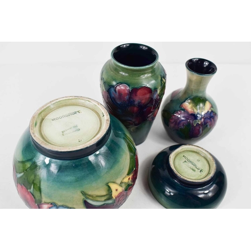 81 - A group of Moorcroft pottery to include two small bud vases, and two bowls, all stamped Moorcroft, t... 
