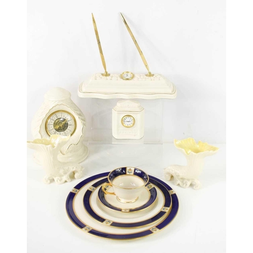 84 - A group of Belleek porcelain comprising desk stand, two clocks and a pair of cornucopia vases with y... 