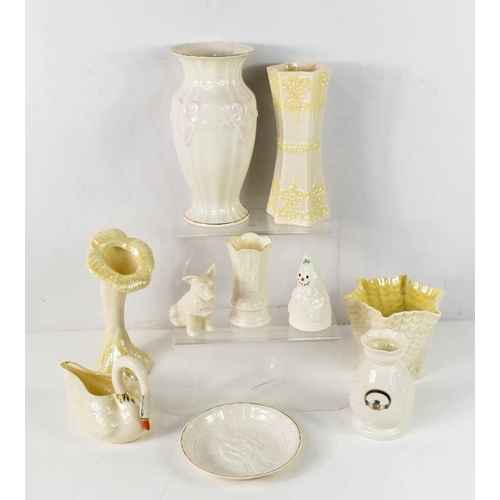 86 - A group of Belleek porcelain, including a trumpet flower form vase, and twisted coral vase, both wit... 