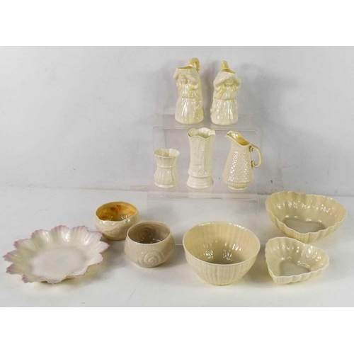 88 - A group of Belleek porcelain including a pair of Undine cream jugs with yellow detailing to the hair... 