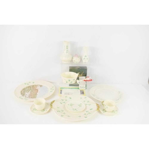 89 - A group of Belleek wares, all decorated with shamrocks, including a shillelagh, boxed, pair of coffe... 