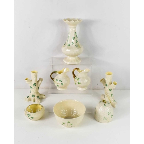 95 - A group of Belleek wares, all decorated with shamrocks, including a pair of tree from vases, pair of... 