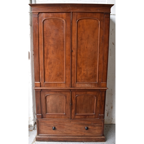 502 - A large Victorian mahogany linen press, the moulded cornice above a pair of panel doors enclosing sl... 