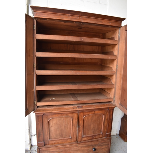 502 - A large Victorian mahogany linen press, the moulded cornice above a pair of panel doors enclosing sl... 