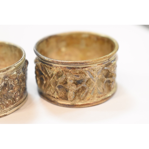 283 - A set of six Indonesian white metal napkin rings in original box marked for Rangoon together with on... 