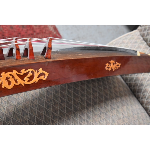 313 - A Chinese Guzheng or zither, made in the traditional form, with hard wood base, fretwork compartment... 