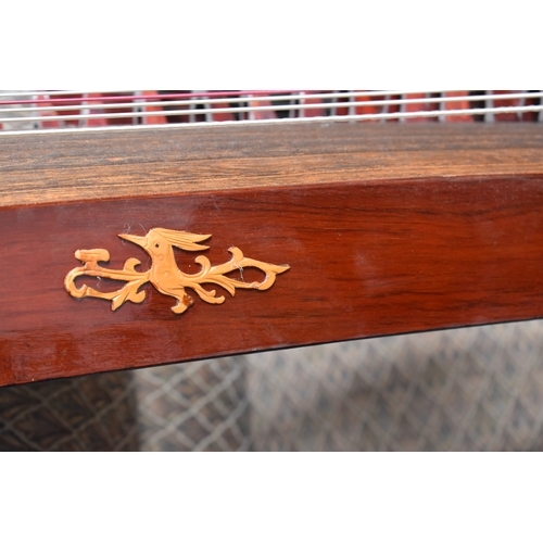 313 - A Chinese Guzheng or zither, made in the traditional form, with hard wood base, fretwork compartment... 