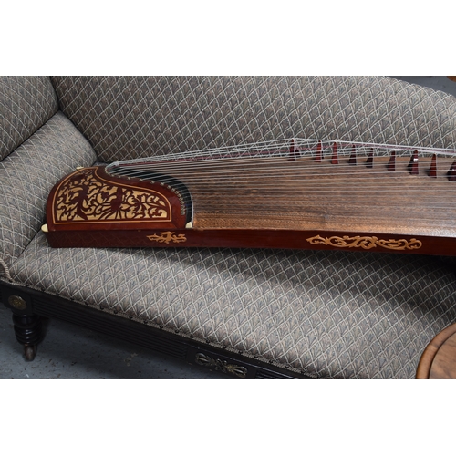 313 - A Chinese Guzheng or zither, made in the traditional form, with hard wood base, fretwork compartment... 