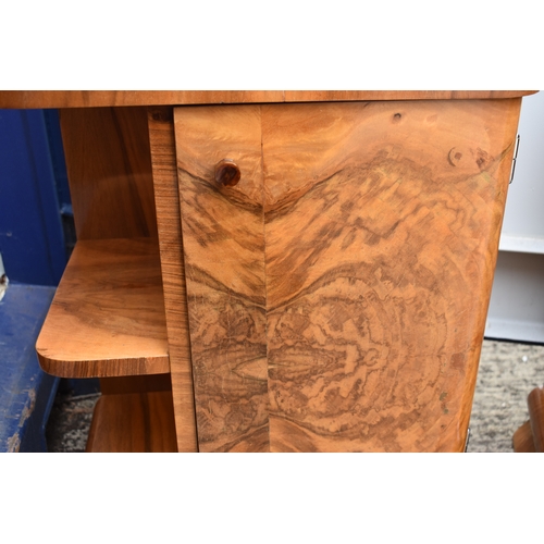 485 - A pair of Art Deco walnut veneer bedside tables, of curvilinear design with bakelite handles, 50 by ... 