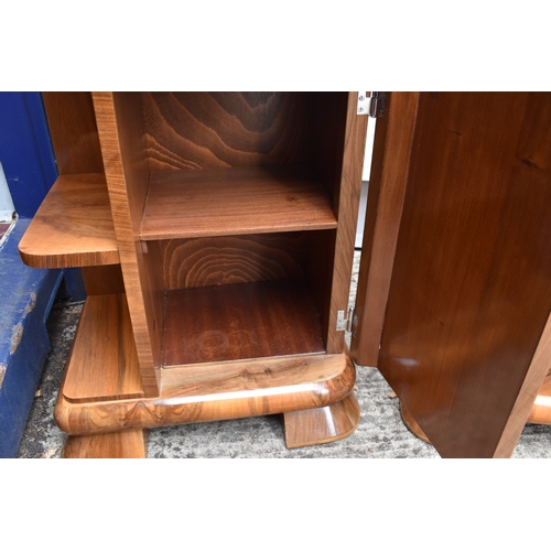 485 - A pair of Art Deco walnut veneer bedside tables, of curvilinear design with bakelite handles, 50 by ... 