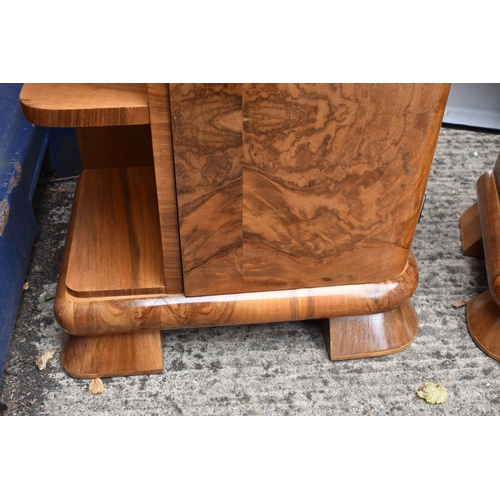 485 - A pair of Art Deco walnut veneer bedside tables, of curvilinear design with bakelite handles, 50 by ... 