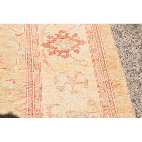 454 - A large Zeigler rug, with a cream ground, decorated with stylised foliate motifs, 4m by 3.17m. This ... 