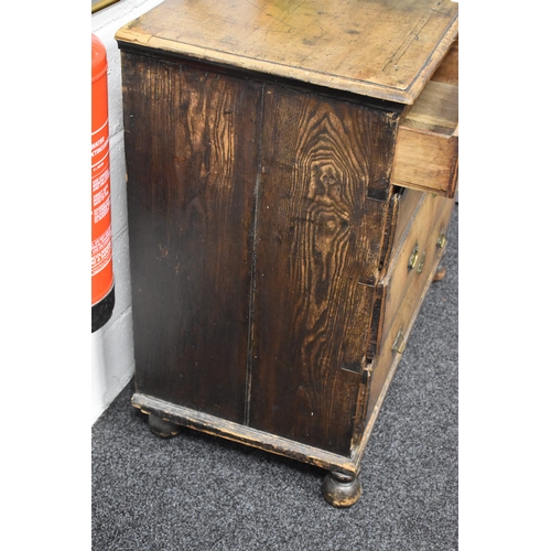 486 - An 18th century walnut chest of two over three drawers, with swan neck handles and brass lock plates... 