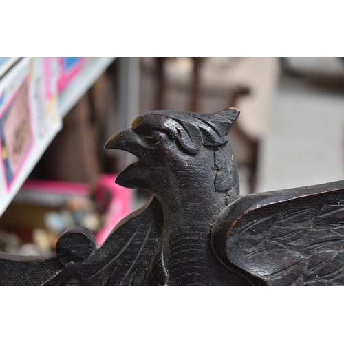 215 - A 19th century carved oak pediment, carved with griffins and fruit, 99cm wide.