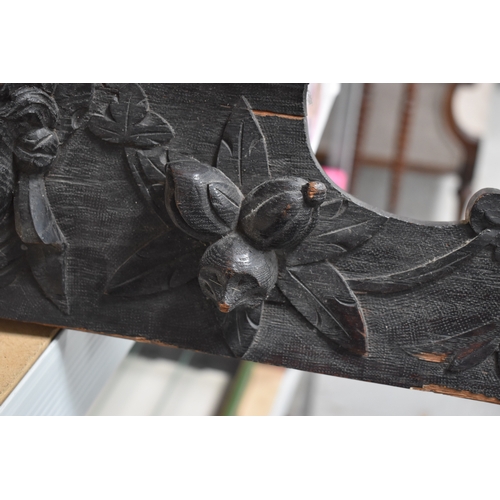 215 - A 19th century carved oak pediment, carved with griffins and fruit, 99cm wide.