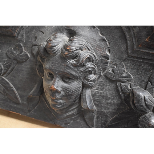 215 - A 19th century carved oak pediment, carved with griffins and fruit, 99cm wide.