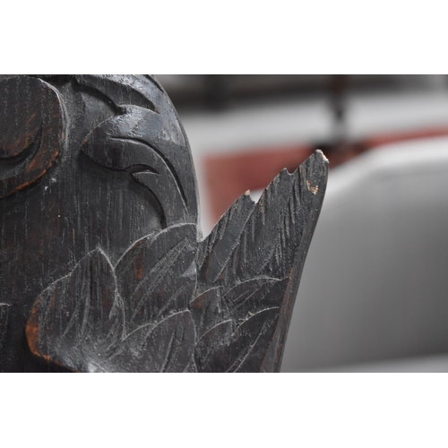 215 - A 19th century carved oak pediment, carved with griffins and fruit, 99cm wide.