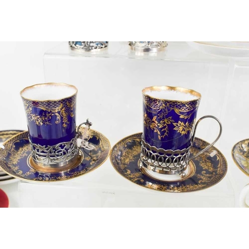 9 - A selection of fine porcelain coffee demitasse, including examples with silver holders. The various ... 