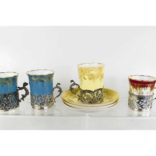 9 - A selection of fine porcelain coffee demitasse, including examples with silver holders. The various ... 