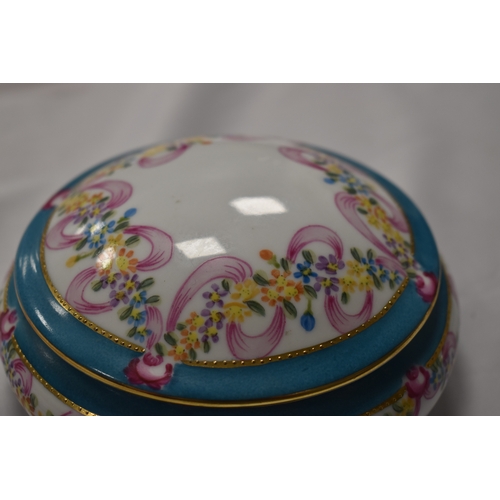 42 - A Russian Gardner porcelain box, with turquoise blue ground bordering the vista painted with a music... 