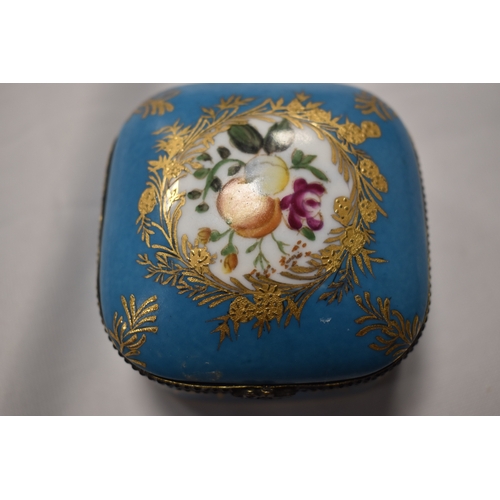 42 - A Russian Gardner porcelain box, with turquoise blue ground bordering the vista painted with a music... 