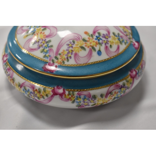 42 - A Russian Gardner porcelain box, with turquoise blue ground bordering the vista painted with a music... 