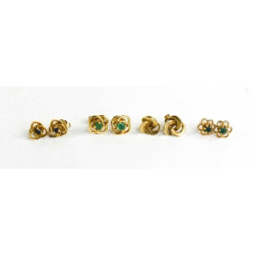 100 - Four pairs of 9ct gold earrings, of swirl design, two pairs having emeralds set to the centre, and o... 