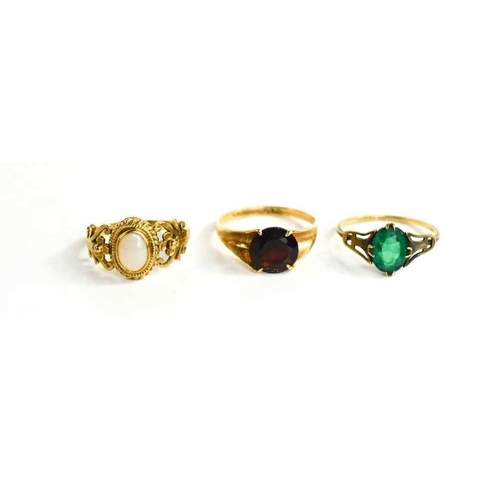 105 - Three 9ct gold rings, to include one set with garnet, one with opal cabochon, and one with green pas... 