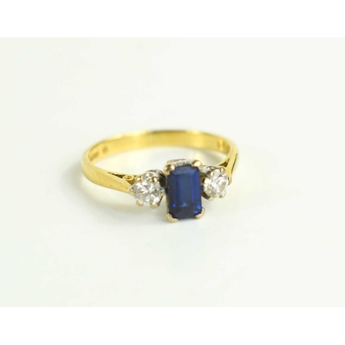 200 - An 18ct gold, cornflower blue sapphire and diamond ring, the baguette cut sapphire 5mm by 4mm, flank... 
