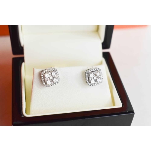 203 - A pair of 18ct white gold and diamond 'Halo' earrings, of square cluster form, the brilliant cut dia... 