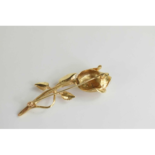 206 - A 14ct gold brooch modelled as a rose set with a pearl to the centre and a ruby to one of the leaf s... 