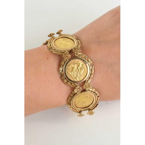 219 - A 9ct gold bracelet set with six half sovereigns, in a pretty laurel leaf and flowerhead setting to ... 