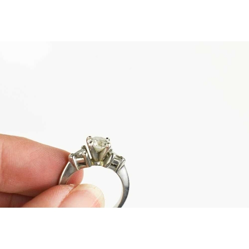 221 - A platinum and diamond ring, composed of a central brilliant cut 1ct diamond, VS1, colour E, flanked... 
