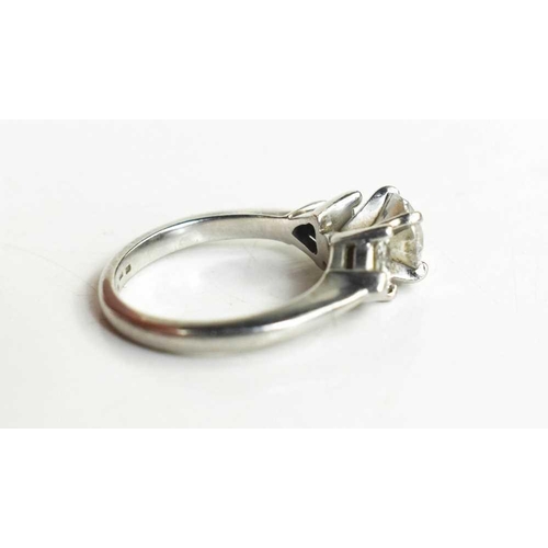 221 - A platinum and diamond ring, composed of a central brilliant cut 1ct diamond, VS1, colour E, flanked... 