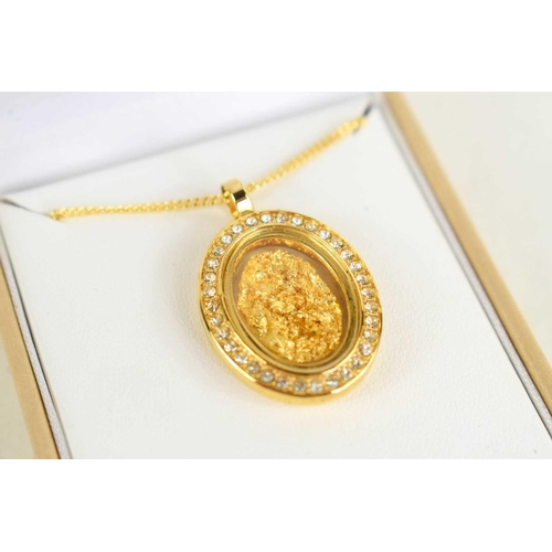 235 - An Australian gold nugget pendant, encapsulated within a decorative oval locket with plated mounts a... 