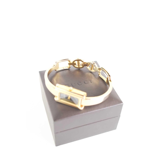 257 - A vintage Gucci mood watch, the signed rectangular dial changes colour from black, through shell pin... 