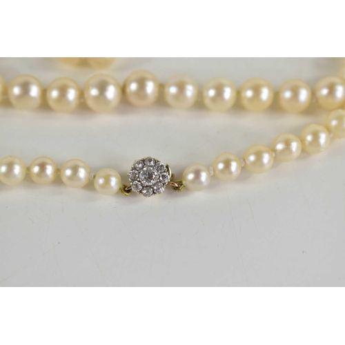 57 - An antique cultured pearl necklace with 9ct gold clasp set with paste stones in flowerhead form, gra... 