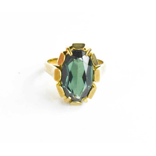 60 - An 8ct modernist style dress ring, set with a large oval green stone, likely paste, marked 333 GB, 1... 