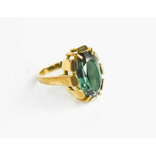 60 - An 8ct modernist style dress ring, set with a large oval green stone, likely paste, marked 333 GB, 1... 