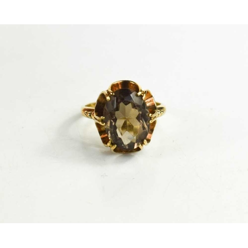 61 - A 9ct gold and smokey quartz dress ring with curvilinear mount in the Modernist style, size I, 3.0g.
