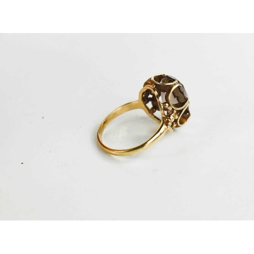 61 - A 9ct gold and smokey quartz dress ring with curvilinear mount in the Modernist style, size I, 3.0g.