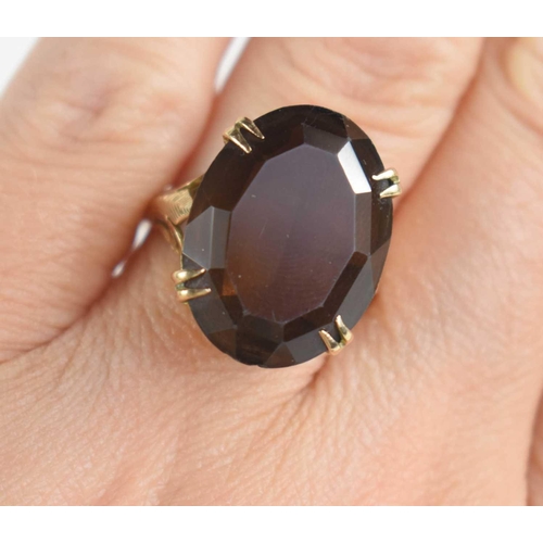 63 - A 9ct gold and quartz dress ring, the 19th century style raised and pierced setting set with oval cu... 