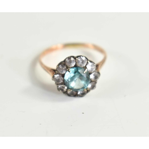 65 - A 9ct gold and paste cluster ring set with an aquamarine coloured central stone encircled with white... 
